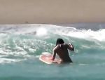 Brünette spielt in der Brandung am Surfboard #1